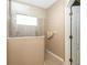 Shower with neutral tiling and a glass partition, complemented by a window for natural light at 11813 Crawford Parrish Ln, Parrish, FL 34219