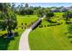 Scenic community walking path winds through lush greenery and past a charming wooden bridge at 11813 Crawford Parrish Ln, Parrish, FL 34219