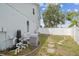 The backyard has equipment, a white fence, grass, and a stepping stone path in a suburban neighborhood at 12102 Steppingstone Blvd, Tampa, FL 33635