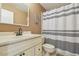 Bathroom featuring a vanity with a marble countertop, a toilet, and a shower with a striped curtain at 12102 Steppingstone Blvd, Tampa, FL 33635