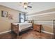 Inviting bedroom with hardwood floors, a comfortable bed, and a window providing natural light at 12102 Steppingstone Blvd, Tampa, FL 33635