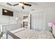 Cozy bedroom with a ceiling fan, a large dresser, and a closet, offering ample storage space at 12102 Steppingstone Blvd, Tampa, FL 33635