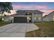 Beautiful two-story home featuring a two-car garage and well-maintained landscaping, perfect for suburban living at 12102 Steppingstone Blvd, Tampa, FL 33635