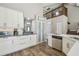 Open kitchen with stainless steel appliances, modern cabinets, wood flooring, and breakfast bar at 12102 Steppingstone Blvd, Tampa, FL 33635