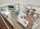 Aerial view of open concept kitchen with white cabinetry, stainless appliances, and center island with bar seating at 12102 Steppingstone Blvd, Tampa, FL 33635