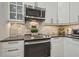 Well-equipped kitchen features modern stainless steel appliances and beautiful marble backsplash at 12102 Steppingstone Blvd, Tampa, FL 33635