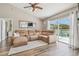Comfortable living room with a large sectional sofa, a fireplace, and sliding glass doors at 12102 Steppingstone Blvd, Tampa, FL 33635