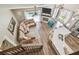 Open-concept living space with kitchen, island seating, and comfortable sofa, offering scenic views and modern design at 12102 Steppingstone Blvd, Tampa, FL 33635