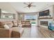 Cozy living room features a fireplace, wood floors, and a large leather sectional at 12102 Steppingstone Blvd, Tampa, FL 33635