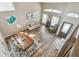 Open-concept living area with high ceilings, wood floors, and modern furnishings, creating a bright and airy atmosphere at 12102 Steppingstone Blvd, Tampa, FL 33635