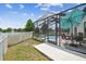 Screened-in pool with outdoor seating perfect for relaxing and entertaining with views of the fenced-in yard at 12102 Steppingstone Blvd, Tampa, FL 33635