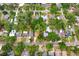 An aerial view shows the property nestled among lush trees in a vibrant neighborhood at 1213 E Idlewild Ave, Tampa, FL 33604