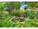 Backyard garden pond featuring lush greenery and a stone waterfall feature at 1213 E Idlewild Ave, Tampa, FL 33604