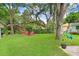 Expansive backyard featuring seating around a fire pit and mature shade trees at 1213 E Idlewild Ave, Tampa, FL 33604