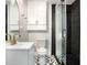 Stylish bathroom featuring modern fixtures, glass shower, and unique black-and-white tile at 1213 E Idlewild Ave, Tampa, FL 33604