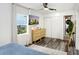 Bright bedroom featuring a TV, dresser, closet, and ample natural light at 1213 E Idlewild Ave, Tampa, FL 33604