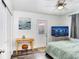 Bright bedroom featuring modern decor, a ceiling fan and a door leading to the outside at 1213 E Idlewild Ave, Tampa, FL 33604