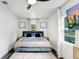Modern bedroom featuring a large bed, natural light, and unique wall decor at 1213 E Idlewild Ave, Tampa, FL 33604
