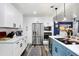 Bright eat-in kitchen features stainless steel appliances and sleek, modern finishes at 1213 E Idlewild Ave, Tampa, FL 33604