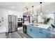 Modern kitchen with stainless steel appliances, blue island, and sleek countertops at 1213 E Idlewild Ave, Tampa, FL 33604