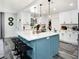 Open kitchen layout with a blue island, breakfast bar, and stainless appliances at 1213 E Idlewild Ave, Tampa, FL 33604