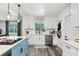 Contemporary eat-in kitchen with stainless steel appliances and blue island at 1213 E Idlewild Ave, Tampa, FL 33604