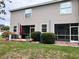 View of back of building with patio and a large lawn at 12268 Country White Cir, Tampa, FL 33635
