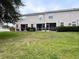 View of back of building with patios and a large lawn at 12268 Country White Cir, Tampa, FL 33635