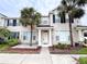 Charming townhome showcasing a beige exterior, palm trees, and a welcoming front entrance at 12268 Country White Cir, Tampa, FL 33635