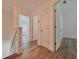 Upstairs hallway with wood flooring and white trim, leading to the bedrooms at 12268 Country White Cir, Tampa, FL 33635