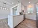 Modern white kitchen offering sleek countertops, stainless steel appliances, and an adjacent dining area at 12268 Country White Cir, Tampa, FL 33635