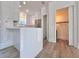 Modern kitchen featuring white cabinets, a breakfast bar, and wood laminate floors at 12268 Country White Cir, Tampa, FL 33635