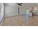 Spacious living room with hardwood floors, modern lighting, and sliding glass doors at 12268 Country White Cir, Tampa, FL 33635