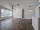Bright and airy living room featuring hardwood floors and modern light fixture at 12268 Country White Cir, Tampa, FL 33635