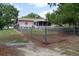Fenced backyard with a view of the home's exterior and a covered patio at 12488 Harper St, Spring Hill, FL 34609