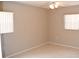 This bedroom has neutral-painted walls, tile floors, and a ceiling fan at 12488 Harper St, Spring Hill, FL 34609
