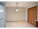 Dining room area includes wood cabinets, tile floors, and a modern light fixture at 12488 Harper St, Spring Hill, FL 34609