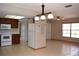 Kitchen with white appliances next to the open layout with dining and living areas at 12488 Harper St, Spring Hill, FL 34609