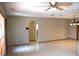 Open living room with a tile floor, neutral walls, and an arched doorway at 12488 Harper St, Spring Hill, FL 34609