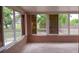 Bright sunroom featuring large windows offering views of the backyard at 12488 Harper St, Spring Hill, FL 34609