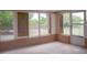 Cozy sunroom featuring wall-to-wall windows that overlook the spacious backyard at 12488 Harper St, Spring Hill, FL 34609