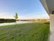 A serene backyard with a beautiful lake view and well-maintained lawn at 13014 Willow Grove Dr, Riverview, FL 33579