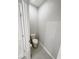 Small powder room includes toilet, gray tile flooring, and fresh gray walls at 13014 Willow Grove Dr, Riverview, FL 33579