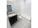 A bathroom featuring granite countertop sink, toilet, and tile shower at 13014 Willow Grove Dr, Riverview, FL 33579