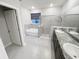 Bathroom featuring a soaking tub, glass enclosed shower, and dual sink vanity at 13014 Willow Grove Dr, Riverview, FL 33579