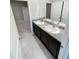 Bathroom features granite countertops and double sinks, as well as tile flooring at 13014 Willow Grove Dr, Riverview, FL 33579