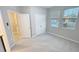 Well-lit bedroom with closet, carpeted floors and natural light from bright windows at 13014 Willow Grove Dr, Riverview, FL 33579