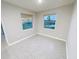 Bright, airy bedroom with neutral walls, tile floors, and two large windows at 13014 Willow Grove Dr, Riverview, FL 33579