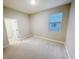 Bright bedroom with neutral paint and carpet and light, with a view to en-suite bathroom at 13014 Willow Grove Dr, Riverview, FL 33579