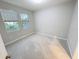 A cozy bedroom with two windows and carpeted floors at 13014 Willow Grove Dr, Riverview, FL 33579